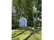 Outdoor storage shed in a grassy backyard shaded by trees at 15101 Bald Eagle St, Tampa, FL 33625
