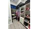 Well-organized walk-in closet featuring custom shelving and ample storage space for clothes and accessories at 15101 Bald Eagle St, Tampa, FL 33625