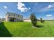 Spacious backyard featuring lush green grass and a covered patio at 16972 Oval Rum Dr, Wimauma, FL 33598
