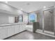 Bathroom featuring dual vanity sinks, soaking tub, and glass shower at 16972 Oval Rum Dr, Wimauma, FL 33598