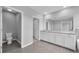 Bathroom with white cabinets, granite countertops, toilet, and open doorway to the bathroom at 16972 Oval Rum Dr, Wimauma, FL 33598