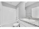 Clean bathroom featuring white tile and granite vanity at 16972 Oval Rum Dr, Wimauma, FL 33598