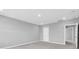 A spacious room with plush carpeting, a white door and neutral paint for a calming atmosphere at 16972 Oval Rum Dr, Wimauma, FL 33598