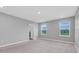 A light, bright bedroom with plush carpeting and a view to the outside at 16972 Oval Rum Dr, Wimauma, FL 33598