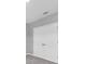 Bedroom with white double door closet, neutral paint, carpet flooring, and modern lighting at 16972 Oval Rum Dr, Wimauma, FL 33598
