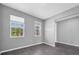 This is a bedroom with two windows and tile floors at 16972 Oval Rum Dr, Wimauma, FL 33598