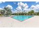 Resort-style community pool featuring lounge chairs and lush landscaping at 16972 Oval Rum Dr, Wimauma, FL 33598