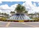 Beautiful entryway featuring an attractive water feature, lush landscaping, and a welcoming ambiance at 16972 Oval Rum Dr, Wimauma, FL 33598