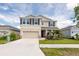 Beautiful two-story home featuring a spacious two car garage and well-maintained landscaping at 16972 Oval Rum Dr, Wimauma, FL 33598