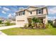 Attractive two-story home with well-kept lawn, attached two car garage, and lovely landscaping at 16972 Oval Rum Dr, Wimauma, FL 33598