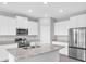 Modern kitchen featuring white cabinetry, stainless steel appliances, and a center island at 16972 Oval Rum Dr, Wimauma, FL 33598