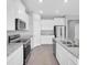 Bright kitchen featuring stainless steel appliances, ample white cabinetry, and a center island at 16972 Oval Rum Dr, Wimauma, FL 33598