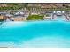 Expansive lagoon view showcasing the vibrant turquoise water, sandy beach, and recreational amenities at 16972 Oval Rum Dr, Wimauma, FL 33598