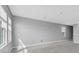 Upstairs living room with carpet and three windows at 16972 Oval Rum Dr, Wimauma, FL 33598