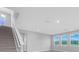 Living room with staircase, large windows and great natural light at 16972 Oval Rum Dr, Wimauma, FL 33598