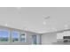 Bright living room featuring large windows and an open floor plan at 16972 Oval Rum Dr, Wimauma, FL 33598