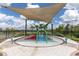 Community splash pad with slide, sprayers and shade at 16972 Oval Rum Dr, Wimauma, FL 33598