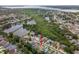 Aerial view of a neighborhood with lake views and lush greenery surrounding well-maintained homes at 1712 Azalea Ct # B, Oldsmar, FL 34677