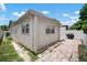 Home's backyard with partial brick-paver patio and BBQ grill at 1712 Azalea Ct # B, Oldsmar, FL 34677