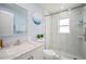 Updated bathroom with a glass shower, marble style tiles, and a modern vanity at 1712 Azalea Ct # B, Oldsmar, FL 34677
