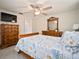 Bedroom with wood furniture, a ceiling fan, and a large window to allow for natural light at 1712 Azalea Ct # B, Oldsmar, FL 34677