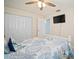 Comfortable bedroom with a coastal vibe, featuring a ceiling fan and wall-mounted TV at 1712 Azalea Ct # B, Oldsmar, FL 34677