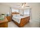 Cozy bedroom with a wood sleigh bed, neutral paint, and large windows for natural light at 1712 Azalea Ct # B, Oldsmar, FL 34677