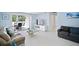 Open-concept living room with tile flooring, neutral paint, and sliding glass doors to the patio at 1712 Azalea Ct # B, Oldsmar, FL 34677