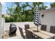 Outdoor patio with dining table, seating, and covered grill, perfect for outdoor dining and entertaining at 1712 Azalea Ct # B, Oldsmar, FL 34677
