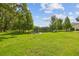 Beautiful backyard with green grass and picturesque lake view, perfect for enjoying nature at 17880 Althea Blue Pl, Lutz, FL 33558