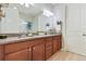 Bathroom featuring double sinks, granite countertop, and stylish lighting at 17880 Althea Blue Pl, Lutz, FL 33558