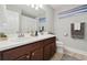 Bathroom featuring double vanity sinks, modern fixtures, and stylish decor to enhance the room's functionality and appeal at 17880 Althea Blue Pl, Lutz, FL 33558