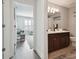 Hallway view to bathroom with a double sink vanity and great natural light at 17880 Althea Blue Pl, Lutz, FL 33558