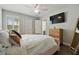 Inviting bedroom showcases a ceiling fan, a comfortable bed, and wood-look flooring at 17880 Althea Blue Pl, Lutz, FL 33558