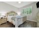 Bedroom with hardwood floors, a decorative bed frame, and bright window views at 17880 Althea Blue Pl, Lutz, FL 33558