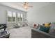 Charming bedroom area with natural light, a decorative teepee, and plush seating that creates a delightful, playful ambiance at 17880 Althea Blue Pl, Lutz, FL 33558