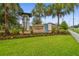Lakeshore Preserve community sign with beautiful landscaping, trees and lush green grass at 17880 Althea Blue Pl, Lutz, FL 33558