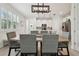 Dining room with stylish furnishings, modern lighting, and a view into the contemporary kitchen at 17880 Althea Blue Pl, Lutz, FL 33558