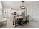 Bright dining area features stylish lighting, a wood table, and kitchen access at 17880 Althea Blue Pl, Lutz, FL 33558