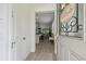 Bright entryway leading to an open-concept living area with hardwood floors and modern finishes at 17880 Althea Blue Pl, Lutz, FL 33558