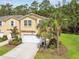 Charming townhome with a well-manicured lawn, landscaping, and an attached garage at 17880 Althea Blue Pl, Lutz, FL 33558