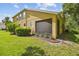Exterior view showcasing a spacious backyard and screened-in porch of this home's charming outdoor living area at 17880 Althea Blue Pl, Lutz, FL 33558