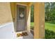 Inviting front entryway with a decorative glass door and a 'hello sunshine' door decoration at 17880 Althea Blue Pl, Lutz, FL 33558
