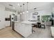 Modern kitchen with white cabinetry, stainless steel appliances, and a center island with seating at 17880 Althea Blue Pl, Lutz, FL 33558