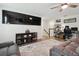 Living room featuring comfortable seating, an entertainment center, and a hallway entrance at 17880 Althea Blue Pl, Lutz, FL 33558