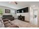 Cozy living room with shuttered windows, gray couches, and a large area rug at 17880 Althea Blue Pl, Lutz, FL 33558