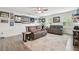 Spacious living room features two gray couches, a ceiling fan, and light gray flooring at 17880 Althea Blue Pl, Lutz, FL 33558