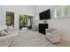 Cozy living room with sliding door to screened porch and modern furnishings at 17880 Althea Blue Pl, Lutz, FL 33558