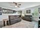 Bright living room offers comfortable seating, a ceiling fan, and ample natural light at 17880 Althea Blue Pl, Lutz, FL 33558
