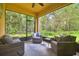 Covered patio with comfortable seating, perfect for enjoying the serene backyard and creating an inviting outdoor living space at 17880 Althea Blue Pl, Lutz, FL 33558